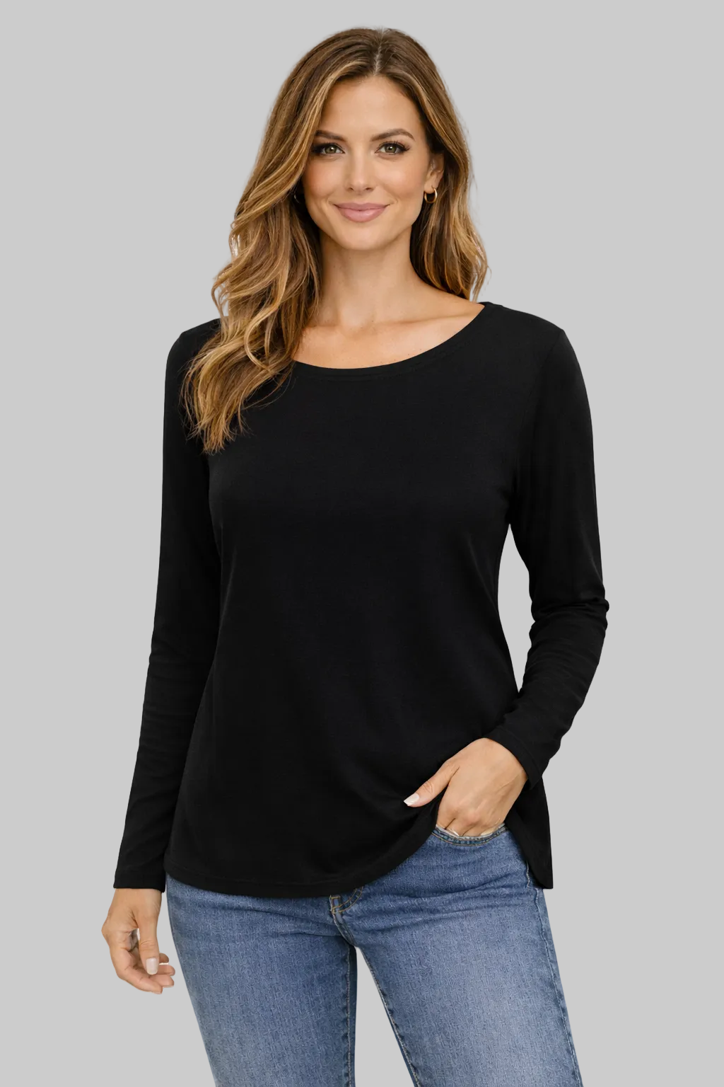 Woman wearing a black long-sleeve top and blue jeans on a white background