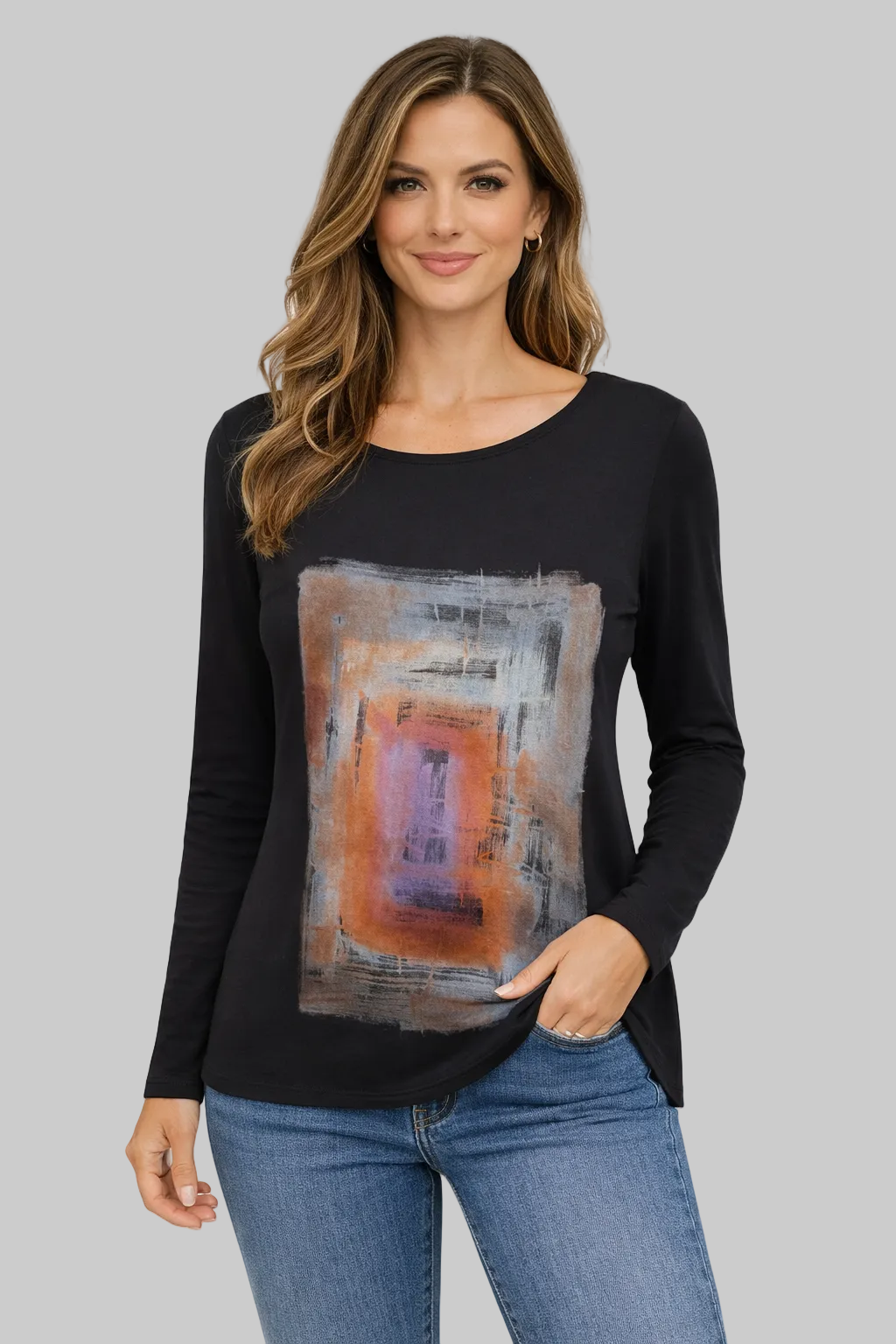 Woman wearing a black long-sleeve top with abstract art design and blue jeans on a white background
